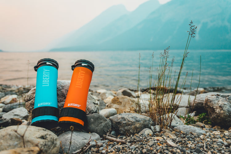 Two Liberty water bottle filters by a lake
