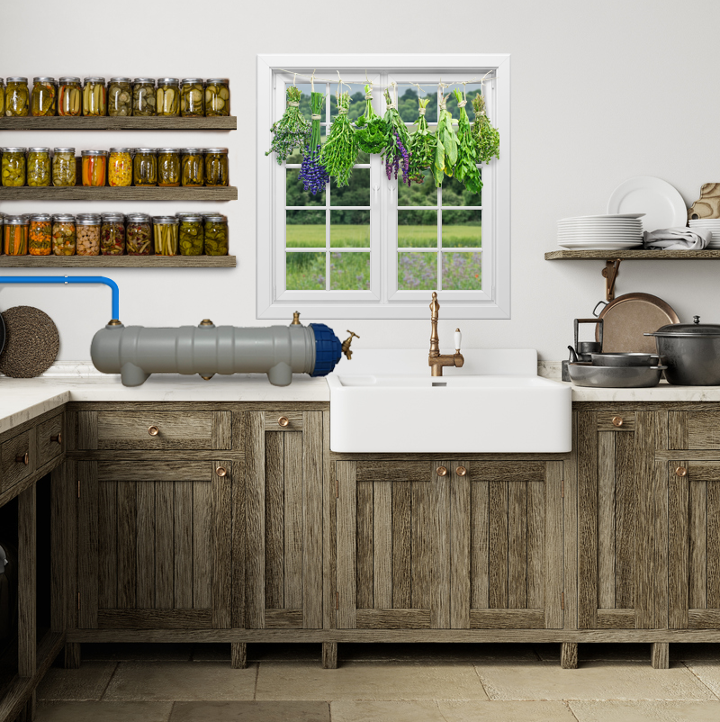 Rustic kitchen with wooden cabinets, a white sink, a window with greenery outside, and a LifeSaver C1 water purifier on the counter. Sheves filled with preserved homegrown food and herbs drying in front of the window